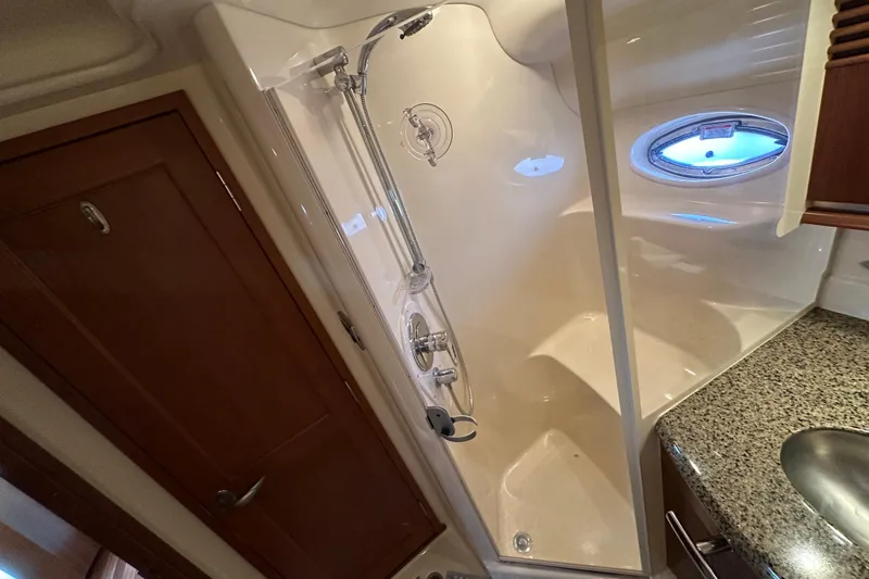 Apres Sea Yacht Photos Pics Shower area in 2006 Sea Ray 52 Sundancer yacht with granite countertop and porthole window.