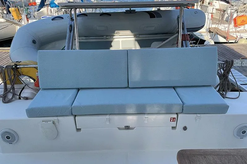  Yacht Photos Pics 2018 Fountaine Pajot Lucia 40 catamaran with blue cushioned seating and inflatable dinghy.