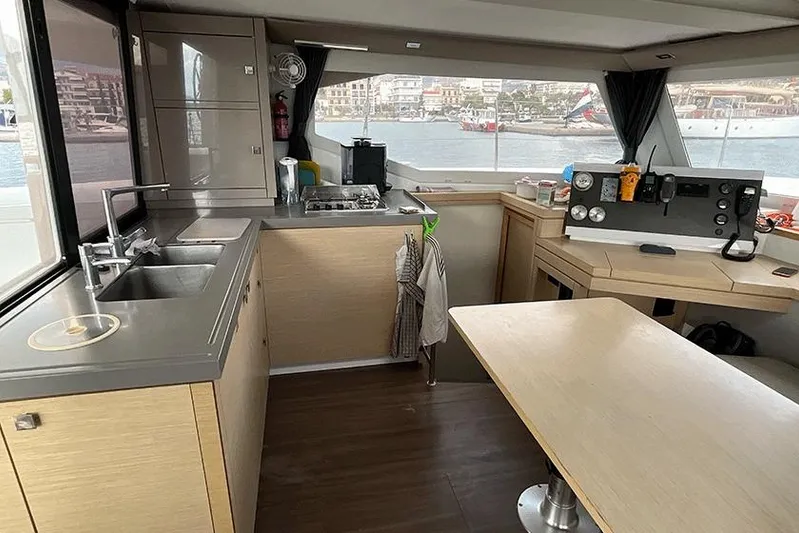  Yacht Photos Pics Interior of 2018 Fountaine Pajot Lucia 40 catamaran with modern kitchen and navigation area.