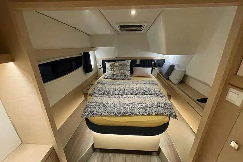  Yacht Photos Pics Luxurious cabin interior of 2018 Fountaine Pajot Lucia 40 catamaran, featuring a cozy bed.