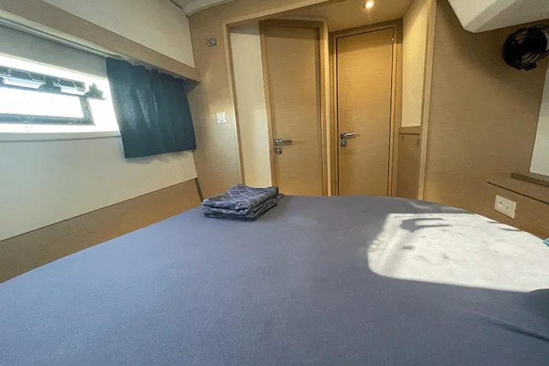  Yacht Photos Pics Cabin interior of 2018 Fountaine Pajot Lucia 40 catamaran with bed and window.