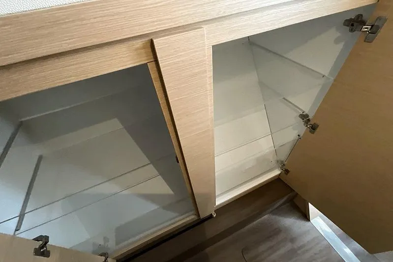  Yacht Photos Pics Empty wooden cabinets inside a 2018 Fountaine Pajot Lucia 40 catamaran.