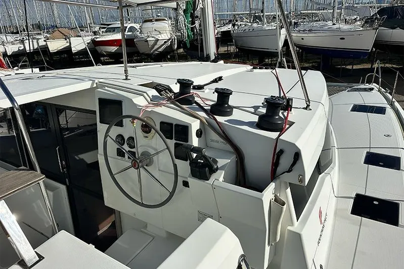  Yacht Photos Pics 2018 Fountaine Pajot Lucia 40 catamaran cockpit with steering wheel and control panel.