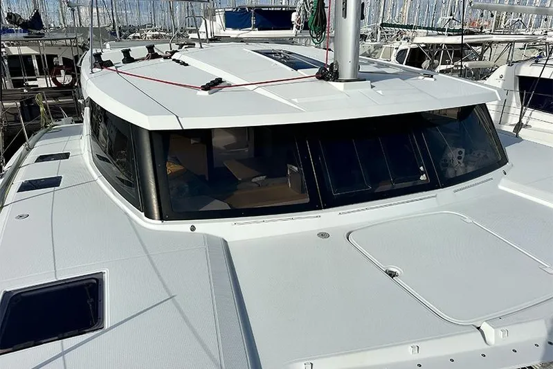  Yacht Photos Pics 2018 Fountaine Pajot Lucia 40 catamaran docked at marina, showcasing sleek design.