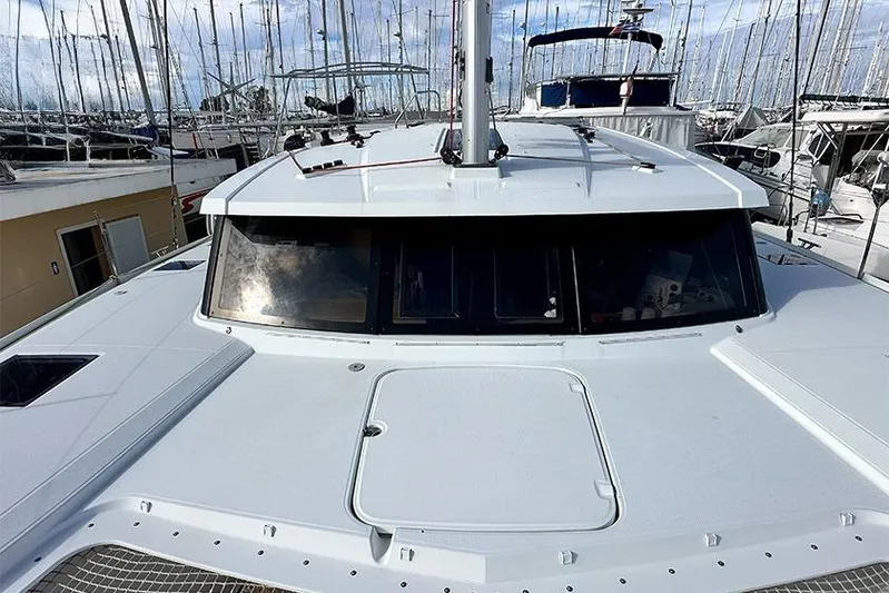  Yacht Photos Pics 2018 Fountaine Pajot Lucia 40 catamaran docked in a marina, showcasing sleek design.