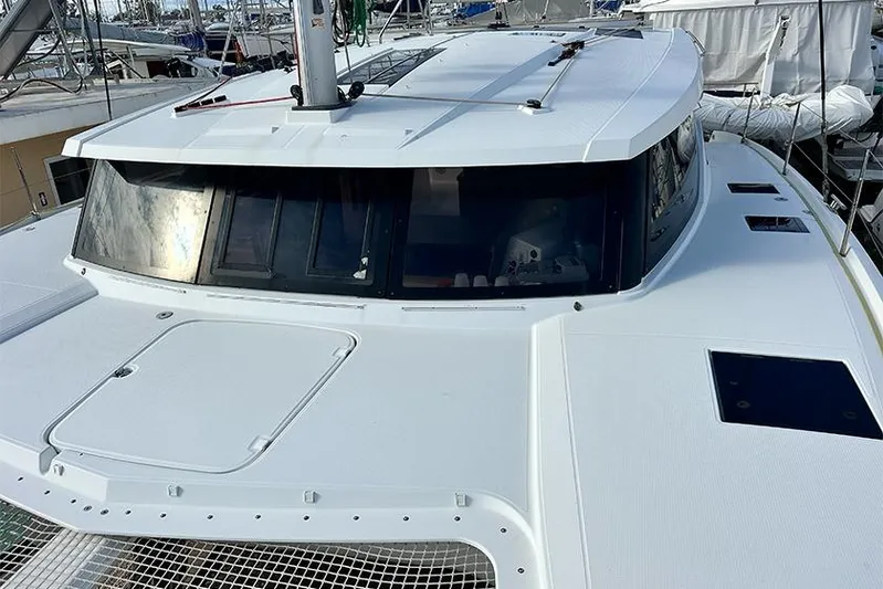  Yacht Photos Pics 2018 Fountaine Pajot Lucia 40 catamaran, docked, showcasing sleek design and spacious deck.