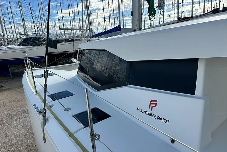  Yacht Photos Pics 2018 Fountaine Pajot Lucia 40 catamaran docked, showcasing sleek design and modern features.