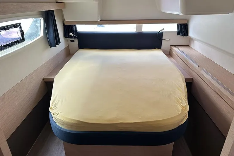  Yacht Photos Pics Cabin interior of 2018 Fountaine Pajot Lucia 40 catamaran with cozy bed and windows.