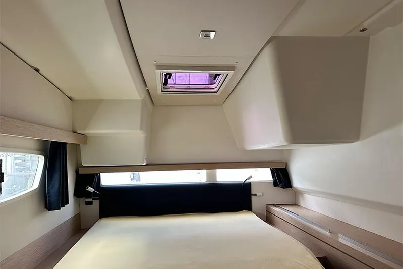  Yacht Photos Pics Interior cabin of 2018 Fountaine Pajot Lucia 40 catamaran, featuring a cozy bed and skylight.