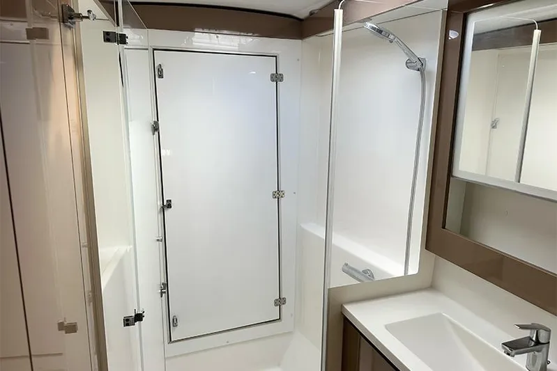  Yacht Photos Pics Modern bathroom interior of 2018 Fountaine Pajot Lucia 40 catamaran, featuring sleek design and fixtures.