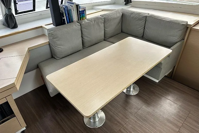  Yacht Photos Pics Interior of 2018 Fountaine Pajot Lucia 40 with cozy seating and wooden table.