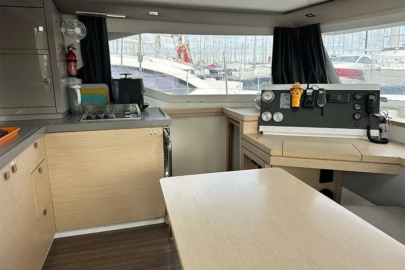  Yacht Photos Pics Interior of 2018 Fountaine Pajot Lucia 40 catamaran with modern kitchen and navigation area.