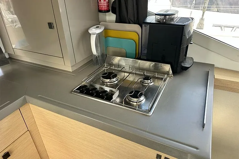  Yacht Photos Pics Compact kitchen area in 2018 Fountaine Pajot Lucia 40 catamaran with stove and appliances.