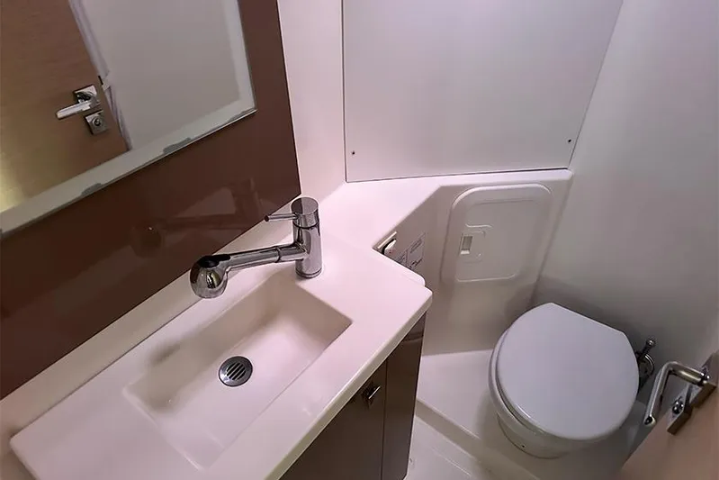  Yacht Photos Pics Modern bathroom in 2018 Fountaine Pajot Lucia 40 yacht, featuring sink and toilet.