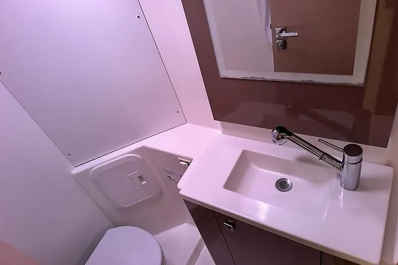  Yacht Photos Pics Bathroom interior of 2018 Fountaine Pajot Lucia 40 catamaran, featuring sink and toilet.