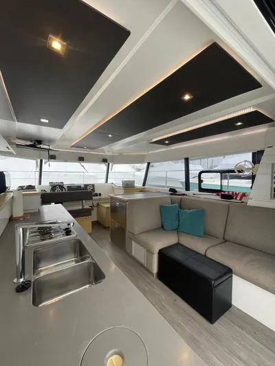  Yacht Photos Pics Interior of 2018 Fountaine Pajot MY 37 yacht, featuring modern kitchen and seating area.
