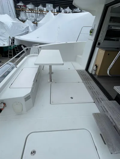  Yacht Photos Pics 2018 Fountaine Pajot MY 37 yacht deck with seating and table, showcasing modern design.