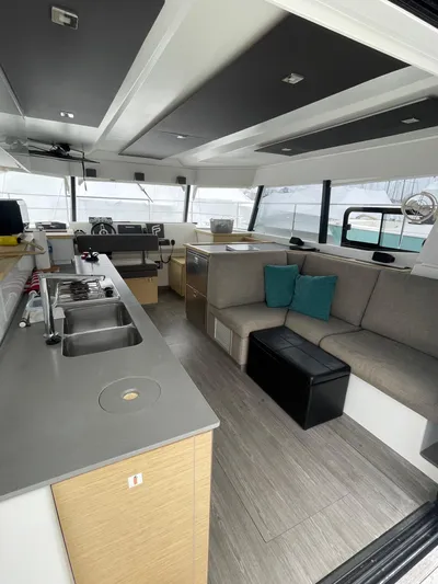  Yacht Photos Pics Modern interior of 2018 Fountaine Pajot MY 37 yacht with sleek kitchen and cozy seating area.