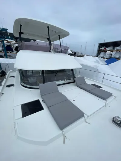  Yacht Photos Pics 2018 Fountaine Pajot MY 37 yacht with sun loungers on deck, docked in a marina.
