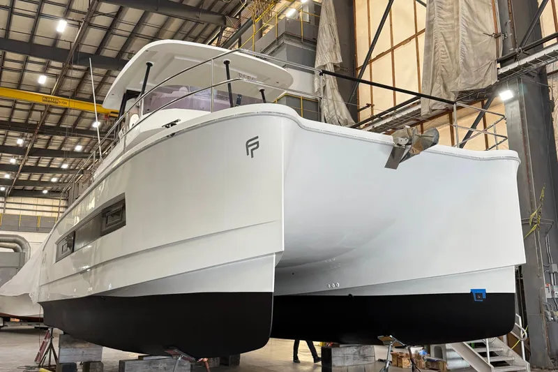  Yacht Photos Pics 2018 Fountaine Pajot MY 37 yacht in a shipyard, elevated on blocks.