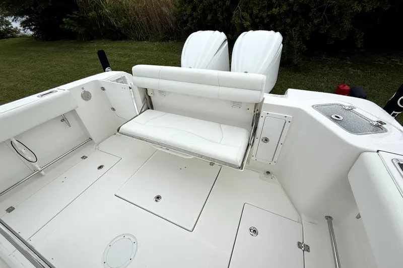  Yacht Photos Pics 2023 Edgewater 285CC boat interior with foldable seating and dual engines.