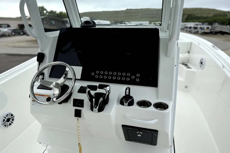  Yacht Photos Pics 2023 Edgewater 285CC boat console with steering wheel and controls.