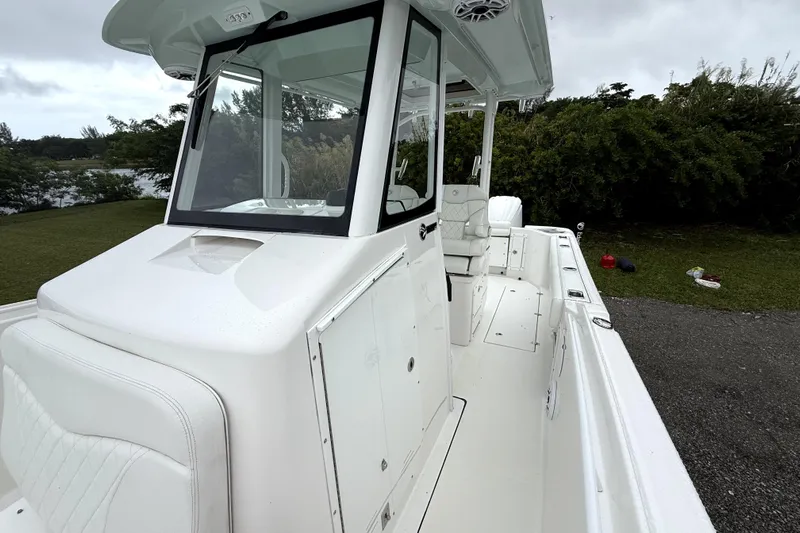  Yacht Photos Pics 2023 Edgewater 285CC boat with sleek white design, spacious deck, and modern console.