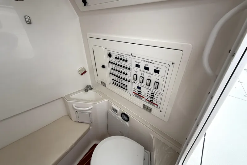  Yacht Photos Pics 2023 Edgewater 285CC boat interior with control panel and compact sink area.