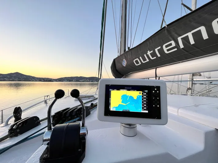 Peems Yacht Photos Pics Outremer 45 sailboat cockpit with navigation display, serene sunset view, 2022 model.