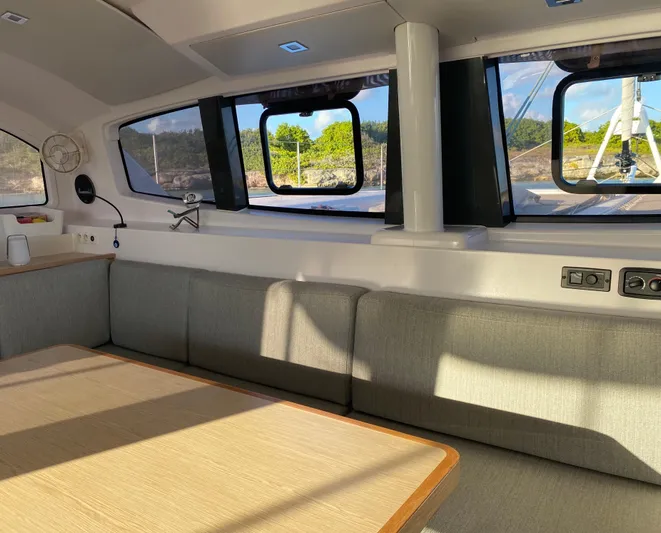 Peems Yacht Photos Pics Interior of 2022 Outremer 45 catamaran, featuring a modern seating area with large windows.
