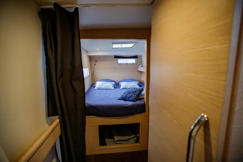 Peems Yacht Photos Pics Interior cabin of 2022 Outremer 45 yacht with cozy bed and modern design.