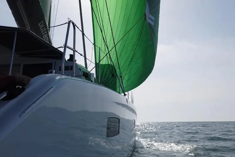 Peems Yacht Photos Pics 2022 Outremer 45 sailing yacht with green sail on open water.