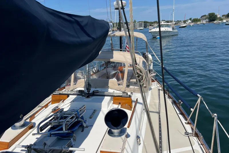 Courage Yacht Photos Pics 1980 Hinckley 43 sailboat on calm water, featuring deck and rigging details.