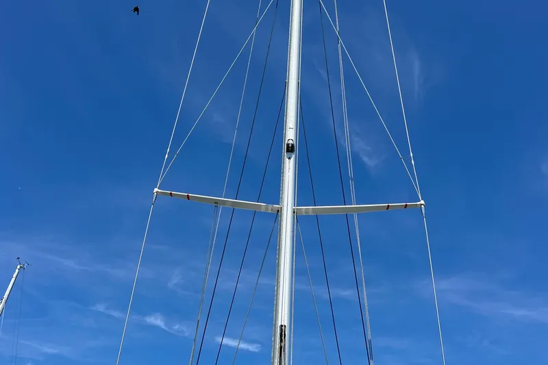 Courage Yacht Photos Pics Mast of 1980 Hinckley 43 sailboat against clear blue sky.