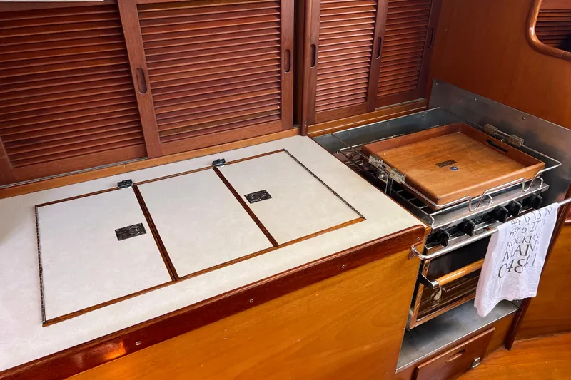 Courage Yacht Photos Pics 1980 Hinckley 43 yacht kitchen with wooden cabinets and stove.