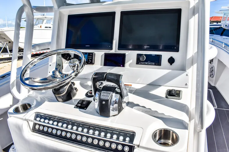  Yacht Photos Pics 2022 Invincible 33 Open Fisherman boat dashboard with dual screens and steering wheel.