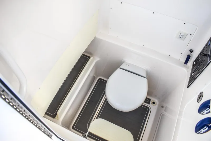  Yacht Photos Pics 2022 Invincible 33 Open Fisherman boat interior with compact marine toilet.