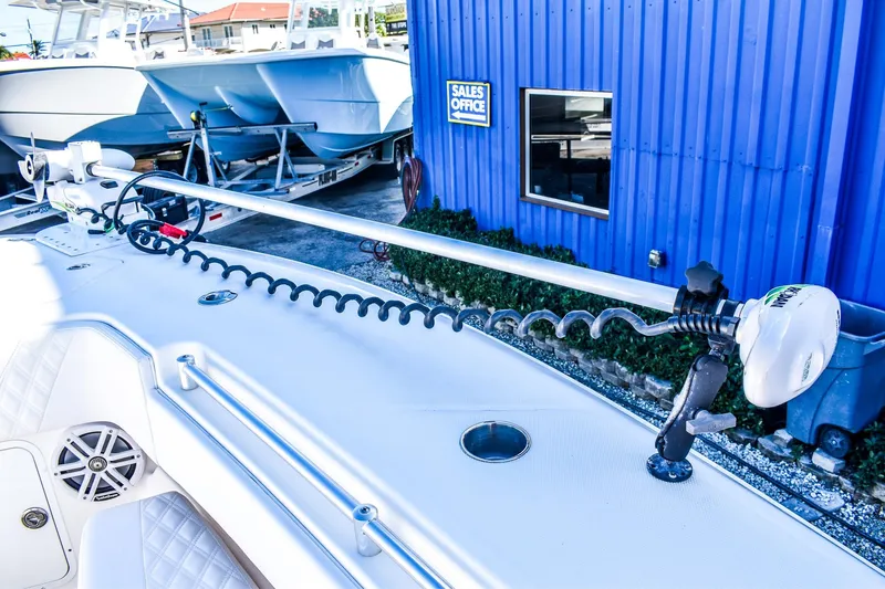  Yacht Photos Pics 2022 Invincible 33 Open Fisherman boat with trolling motor, docked near sales office.