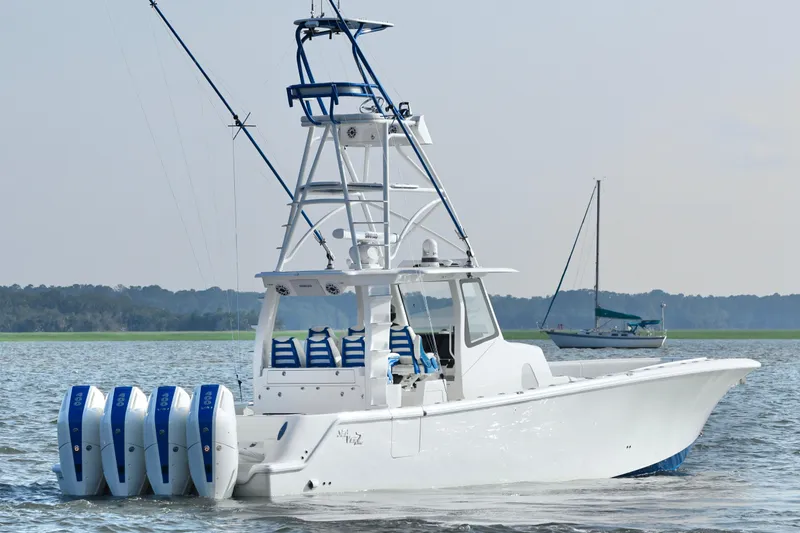  Yacht Photos Pics 2024 SeaVee 420Z boat with four engines on calm water, featuring a sleek design.