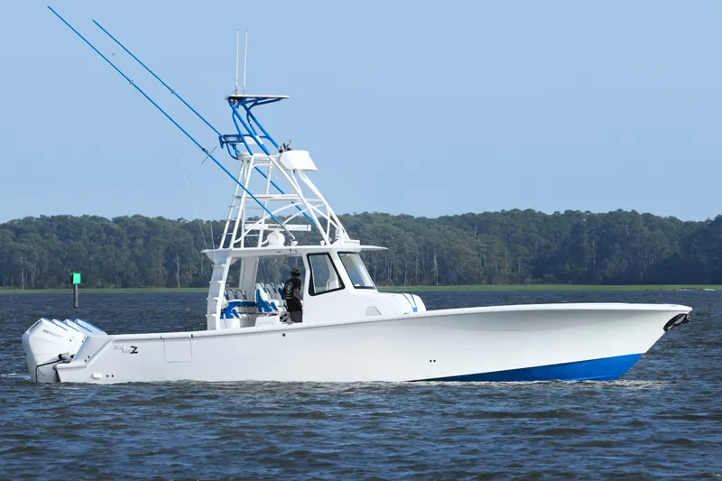  Yacht Photos Pics 2024 SeaVee 420Z boat cruising on a calm lake with forested shoreline.