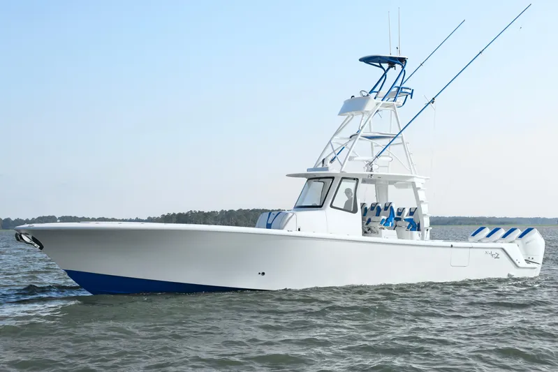  Yacht Photos Pics 2024 SeaVee 420Z boat cruising on open water, showcasing sleek design and fishing equipment.