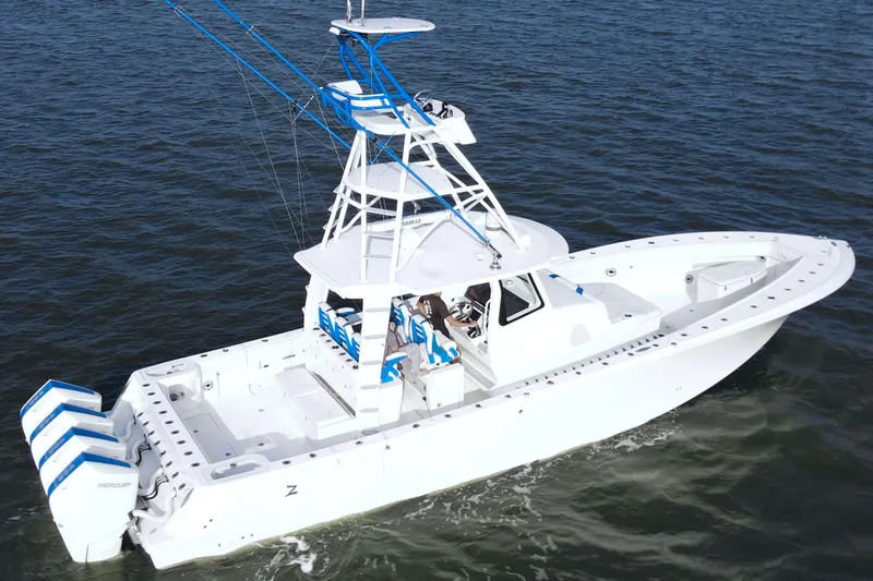  Yacht Photos Pics 2024 SeaVee 420Z boat cruising on open water, featuring multiple outboard engines.