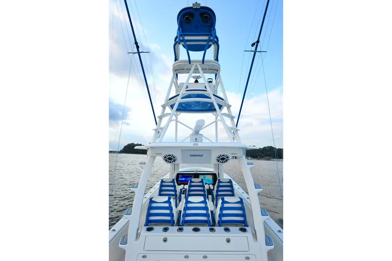  Yacht Photos Pics 2024 SeaVee 420Z boat with blue-striped seating and tower, on calm water.