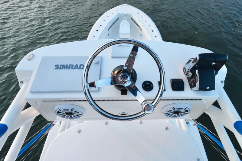  Yacht Photos Pics 2024 SeaVee 420Z boat helm with Simrad electronics and steering wheel, on calm water.