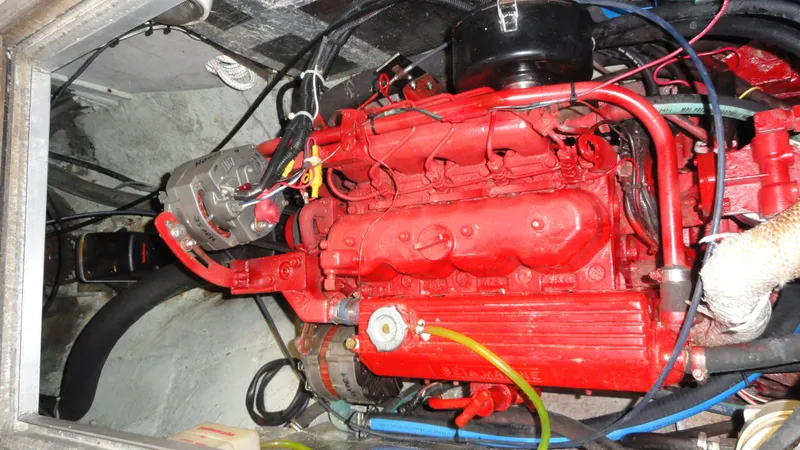 Courage Yacht Photos Pics Red engine of a 1980 Hinckley 43 boat, showcasing intricate mechanical components.