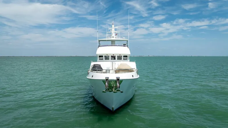 Take 5 Yacht Photos Pics Nordhavn 76 yacht from 2009 on open sea under blue sky.