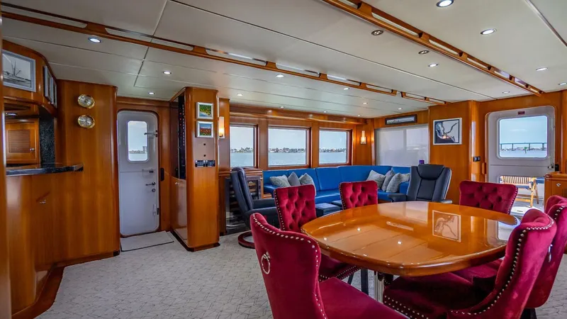 Take 5 Yacht Photos Pics Luxurious interior of 2009 Nordhavn 76 yacht with elegant dining area and plush seating.