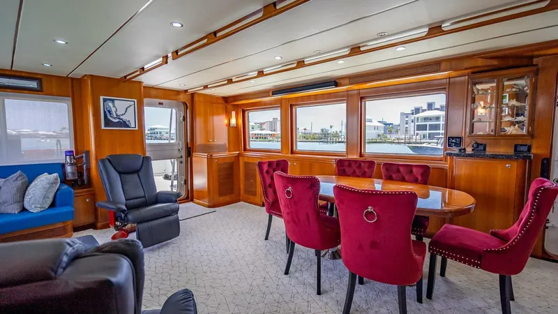 Take 5 Yacht Photos Pics Luxurious interior of 2009 Nordhavn 76 yacht with elegant dining area and plush seating.