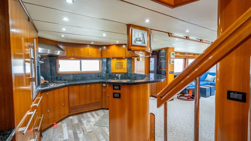 Take 5 Yacht Photos Pics Luxurious 2009 Nordhavn 76 yacht interior with modern kitchen and elegant wood finishes.