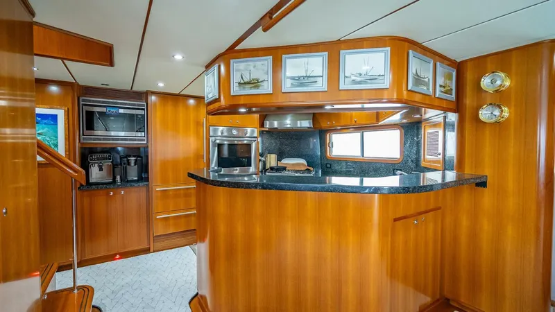 Take 5 Yacht Photos Pics Luxurious 2009 Nordhavn 76 yacht interior with elegant wood cabinetry and modern kitchen appliances.